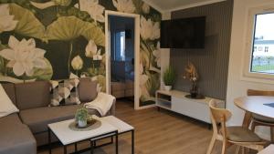 a living room with a couch and a table at LandZeit - get your tiny moments in Sohren