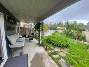 a backyard patio with a couch and a table at Grizzly Glacier in Columbia Falls
