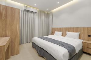 a bedroom with a large bed and a window at New Karam Suites in Riyadh +53 photos