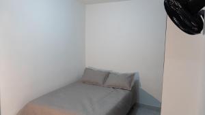 a bed with two pillows on it in a room at james house in Cali