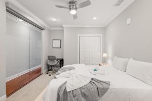 ein weißes Schlafzimmer mit einem großen Bett und einem Stuhl in der Unterkunft Luxury 1BR - Glass Wall & Window in Philadelphia + 34 Fotos