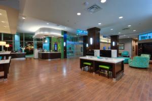 a lobby of a hotel with tables and chairs at Holiday Inn Saskatoon Downtown by IHG in Saskatoon +102 photos