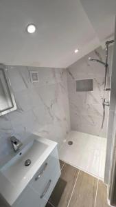 a white bathroom with a shower and a sink at ZE Luxurious House Paris - Suite de luxe in Argenteuil +49 photos