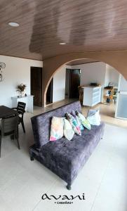a couch with pillows on it in a living room at Cabañas Avani in San Francisco +28 photos