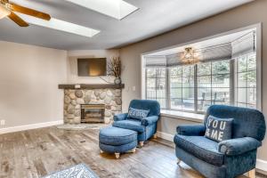 a living room with two chairs and a fireplace at Quelah Lane 8 in Sunriver