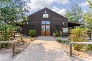 a barn with a sign on the front of it at Quelah Lane 8 in Sunriver