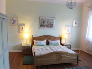 a bedroom with a wooden bed with two lamps at Holiday home in Breetz üb Lenzen in Breetz