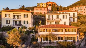 a group of houses on a hill with trees at Miramaretellaro in Tellaro