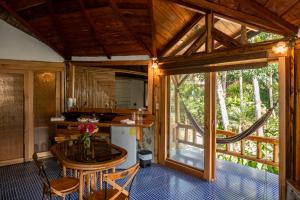 a small kitchen with a table in a house at Saguamby Mindo Lodge in Mindo
