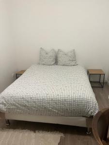 a bedroom with a bed with two pillows on it at suresnes centre in Suresnes