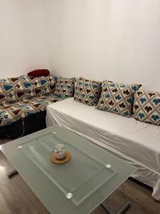 a couch with a coffee table with a cup on it at suresnes centre in Suresnes