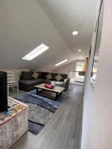 a living room with a couch and a table at Lovely newly refurbished, 1 bedroom top floor apartment with sea views, fast WI-FI CABLE TV and Netflix in Ribeira Brava