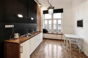 a kitchen with a sink and a table in it at CityNest Apartments in Krakow