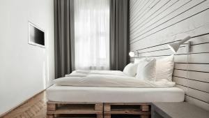 a bedroom with two beds and a large window at CityNest Apartments in Kraków