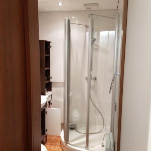 a bathroom with a shower with a glass at Studio in the heart of Juodkrante in Juodkrantė