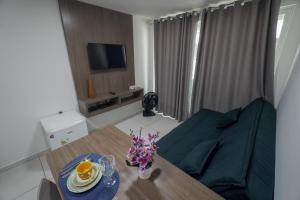 a living room with a couch and a table at Israel flat Tambau 115 in João Pessoa