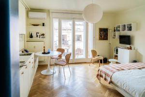 a bedroom with a bed and a table and chairs at Pannonia View Delight in Budapest