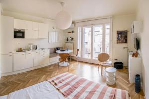 a kitchen with white cabinets and a table and chairs at Pannonia View Delight in Budapest