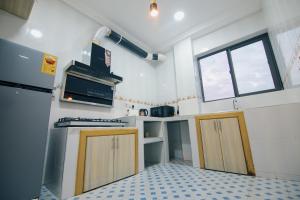 a small kitchen with two doors and a window at Big chill stays East Legon in Accra