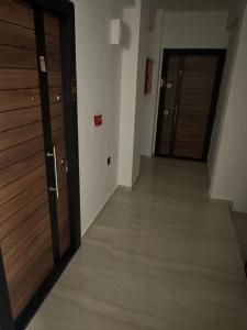 an empty hallway with two wooden doors in a building at NIKA The architect DIAMOND OF GEVGELIA in Gevgelija