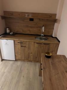 a kitchen with a sink and a wooden counter at NIKA The architect DIAMOND OF GEVGELIA in Gevgelija