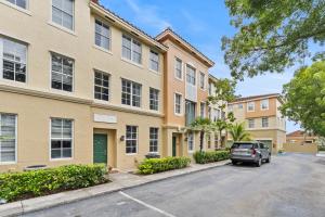 a car parked in front of a building at Bayside Townhome - Private Beach Access, Pool and Hot Tub, Free Parking in Golden Isles