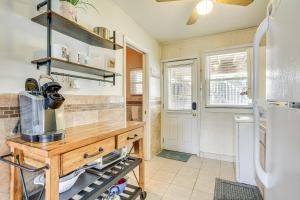 a kitchen with a wooden table and a refrigerator at Wildwood Crest Retreat Walk to Beach and Boardwalk! in Wildwood Crest