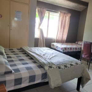 Ένα ή περισσότερα κρεβάτια σε δωμάτιο στο Delapaix Guest lodge