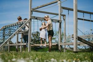 a woman and a little girl standing on a board at Sunrise Luxurious holiday home in Cubert