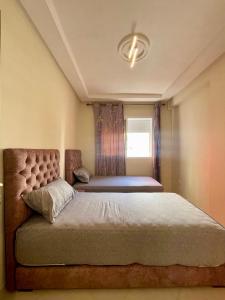 Ένα ή περισσότερα κρεβάτια σε δωμάτιο στο Appartement Haut Standing en Plein Coeur de la Ville