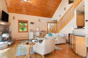 a kitchen and living room with wooden ceilings at Lakefront-hot Tub Gym Kayaks Paddleboards in Thompson