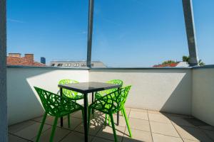 a table and chairs on a balcony with a view at Vienna Residence, Prater - Exhibition Center in Vienna +195 photos