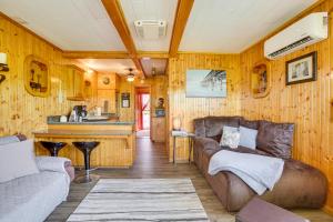 a living room with a couch and a kitchen at Da Boat House with World-Class Bayou Fishing! in Houma