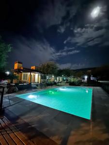 a swimming pool at night with the moon in the sky at Colibríes en Las Moreras in Merlo