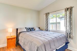 a bedroom with a large bed and a window at 3 Mi to Duke Downtown Durham Cottage! in Durham