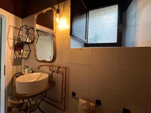 a bathroom with a sink and a mirror at Maison Le Calle in Vallo di Nera +23 photos