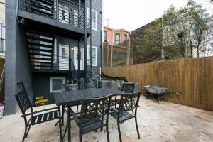 a patio with a table and chairs and a fence at Modern LUX 2BR Apartment in DC with Patio in Washington