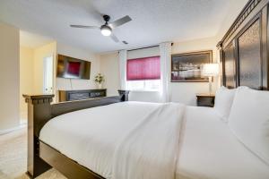 a bedroom with a large white bed and a window at Furnished Deck and Grill Reno Getaway! in Reno