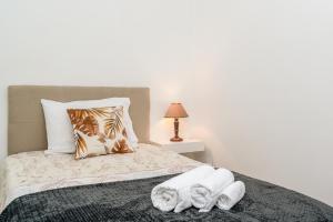 a bedroom with a bed with towels on it at Atouguia House - Traditional House in Calheta