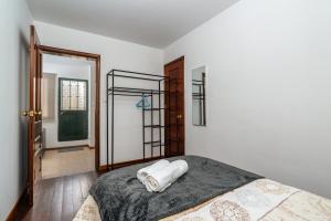 a bedroom with a bed with a towel on it at Atouguia House - Traditional House in Calheta +46 photos