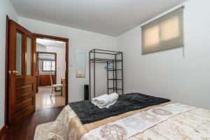 a bedroom with a bed with a towel on it at Atouguia House - Traditional House in Calheta