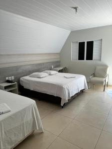 Katil atau katil-katil dalam bilik di Hotel Recanto do Bosque