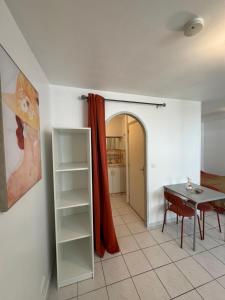 a room with a table and a table and a room with a window at Cocon Studio proche Disneyland in Lagny