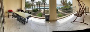 a room with a table and a balcony with a view at درة العروس الحالمة in Durat Alarous