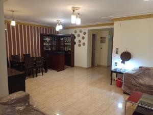 a living room with a table and a dining room at Universal family apartment in Cairo