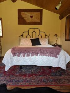 a bedroom with a large bed in a room at Paradise Valley Oasis - Your Yellowstone Base Camp in Flying Y Ranch Airport