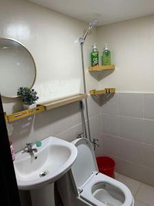 a bathroom with a sink and a toilet and a mirror at Sunny Villa in Angeles +32 photos
