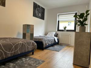 a bedroom with a bed and a window at Greenview Apartment Trier - 3 beds 2 bedrooms in Trier