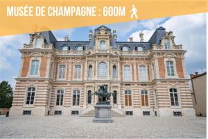 a large building with a statue in front of it at Gite Urbain - Dionysos - Parking in Épernay