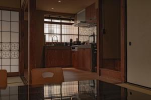 a kitchen with wooden cabinets and a large window at CraftFlat Asakusa House in Tokyo
